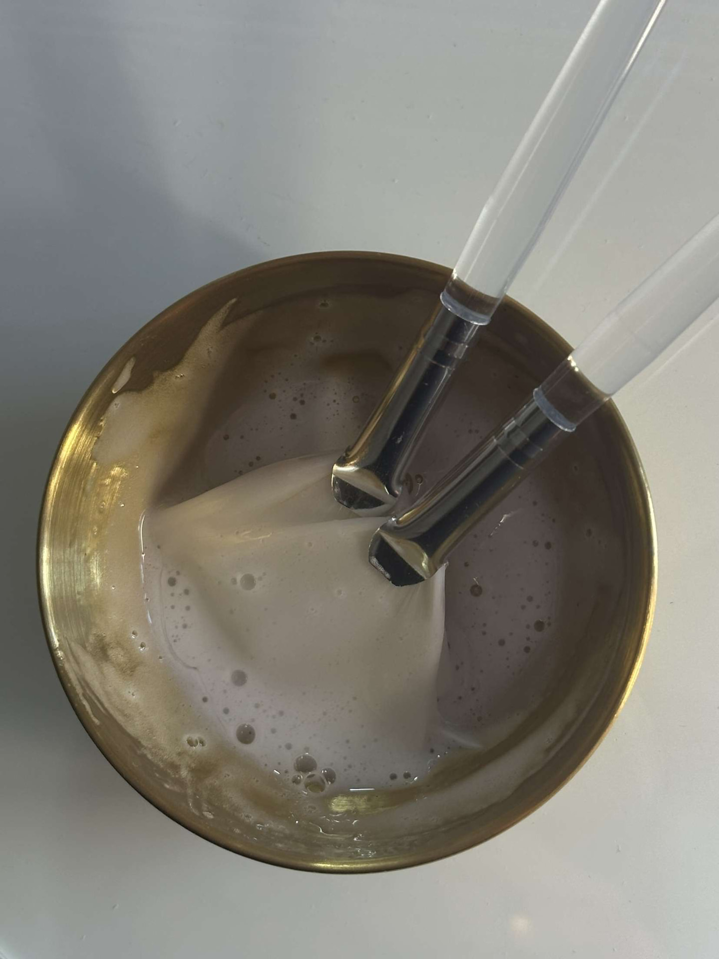 Facial mask mixed in a gold bowl